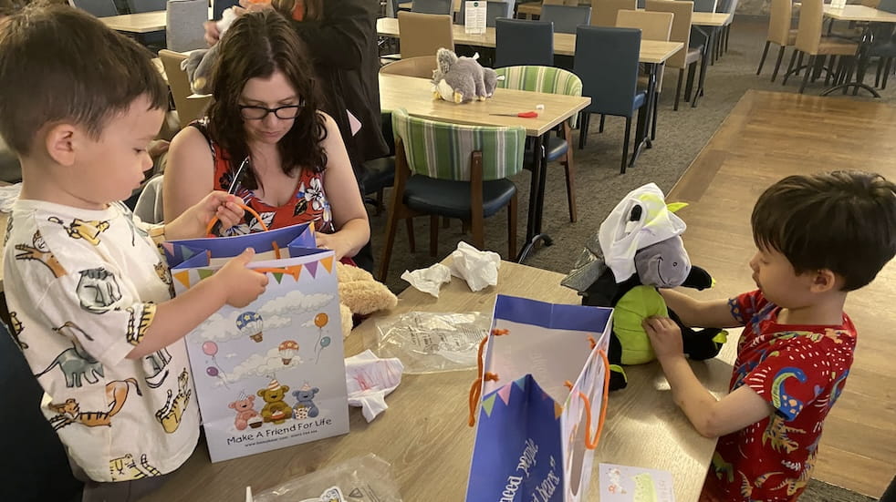 Richard's wife and two boys making teddy bears at Whitemead workshop